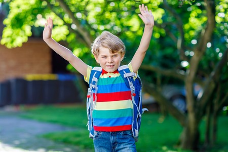 little kid boy with school satchel on first day to schoolの写真素材