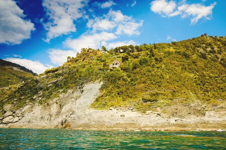 Liguria, Italy coastline of Riviera with colorful houses on sunny warm day. Monterosso al Mare, Vernazza, Corniglia, Manarola and Riomaggiore, Cinque Terre National Park UNESCO World Heritageの写真素材