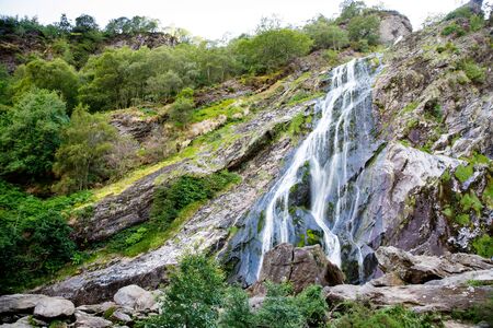 Beautiful water cascade of Powerscourt Waterfall, the highest waterfall in Ireland. Famous tourist atractions in co. Wicklow, Ireland. Near Powerscourt Manor Houseの写真素材