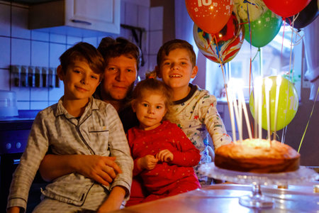 Adorable kid boy celebrating tenth birthday. Toddler Baby child, two kids boys brothers and father...