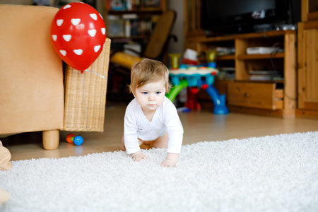 Lovely cute beautiful little baby girl playing with educational toys at home or nursery. Happy...