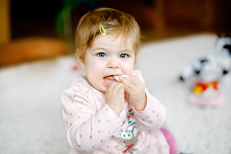 Lovely cute beautiful little baby girl playing with educational toys at home or nursery. Happy...