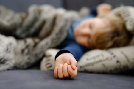 Cute little toddler girl sleeping in bed. Adorable baby child dreaming, healthy sleep of children by...