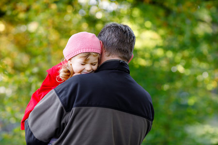 Happy young father having fun cute toddler daughter, family portrait together. Middle-aged Man with...