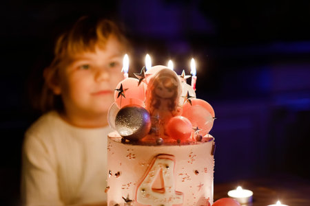 Adorable little toddler girl celebrating fourth birthday. Cute toddler child with homemade princess...