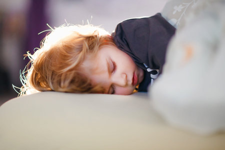 Little toddler child resting on say in parents bed. Adorable kid boy sleeping and dreaming. Peaceful...