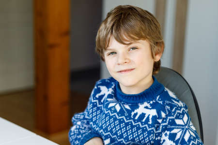 Portrait of little cute school kid boy. Beautiful happy child looking at the camera. Schoolboy smiling. Education concept.の写真素材