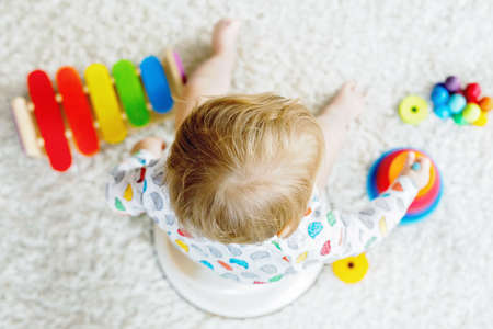 Closeup of cute little 12 months old toddler baby girl child sitting on potty.の写真素材