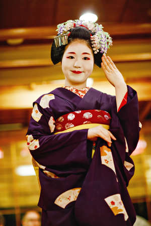 KYOTO, JAPAN - 18 May, 2015: Maiko apprentice showing Japanese traditional dance. Maiko is an apprentice geisha. Maikos performing songs, playing shamisen or instruments for visitors on ozashiki.のeditorial素材