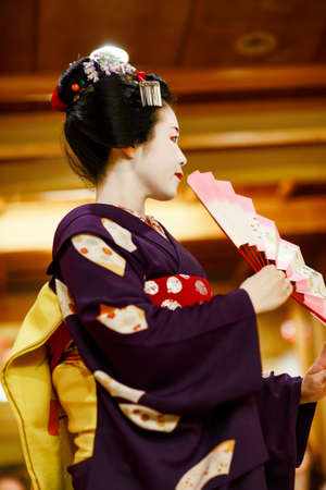 KYOTO, JAPAN - 18 May, 2015: Maiko apprentice showing Japanese traditional dance. apprentice geisha. Maikos performing songs, playing shamisen for visitors on ozashiki. Not official event.のeditorial素材