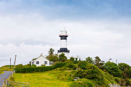 Lighthouse on Inishowen peninsula in North Ireland. Beautiful Wild Atlantic Way with typical irish landscapes, coastline and cliffs.の写真素材