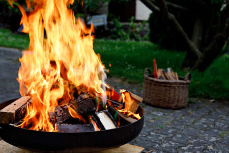 Bonfire with sparks flying around. Summer camp fire for adults and children.の写真素材