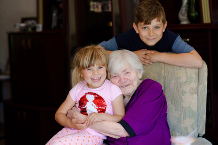 Great-grandmother with three children, siblings. Family of three, school kid boy and little toddler...