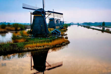 Dutch landscape, windmills at Kinderdijk village, a famous authentic tourism attraction in the Netherlands on sunset.の写真素材