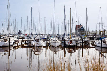 View on harbour of Volendam in the Netherlands. Sail boats on water. North sea.の写真素材