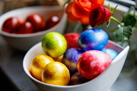 Homemade colored eggs for Easter. Coloring with different rainbow organic colors.の写真素材
