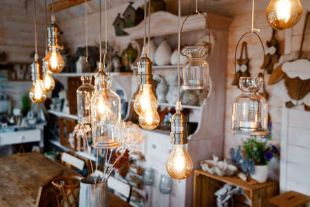 Beautiful arrangement of wooden decor and ceramic decoration in a shop for indoor, outdoor and garden. Light bulb as fairy lights.の写真素材