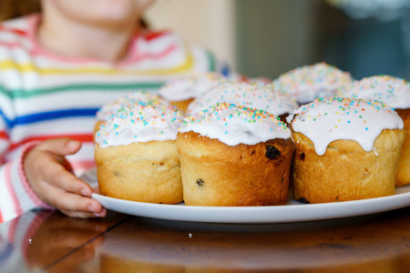 Closeup of little child holding traditional Easter cake called paska in Russian and Ukrainian. Happy...