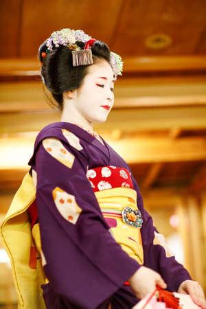 KYOTO, JAPAN - 18 May, 2015: Maiko apprentice showing Japanese traditional dance. Maiko is an apprentice geisha. Maikos performing songs, playing shamisen or instruments for visitors on ozashiki.のeditorial素材