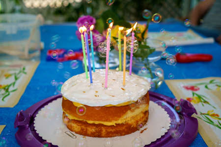 Birthday cake with candles. Sweet dessert for a party.の写真素材