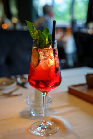 classic aperol cocktail at the bar, Classic italian aperol spritz cocktail in glass on dark . Close...