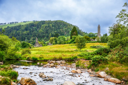 Idyllic view in Glendalough Valley, County Wicklow, Ireland. Mountains, lake and tourists walking pathsの写真素材