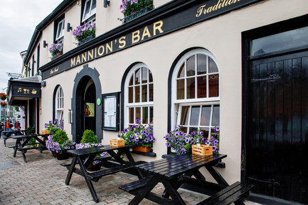 CLIFDEN, IRELAND - 16 July, 2019: Awesome and colorful streets of Clifden, Connemara, Ireland. Colourful houses, doors, pubs, windows with flowers.のeditorial素材