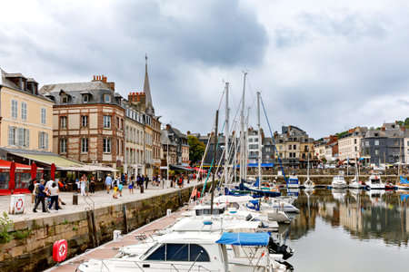 HONFLEUR, FRANCE - August 23, 2022: View of the picturesque harbour of Honfleur, yachts and old houses reflected in waterのeditorial素材