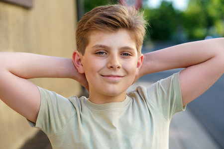 Portrait of handsome preteen school kid boy. Beautiful happy child looking at the camera. Schoolboy smiling. Education concept. Teenager outdoorsの写真素材
