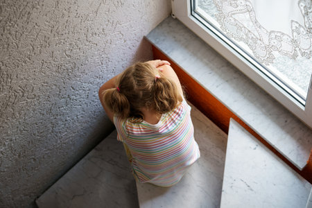 Lonely Upset Little Preschool Girl at Home. Sad Child Alone. Emotional Stress of Children, School, and Family Problems.の写真素材