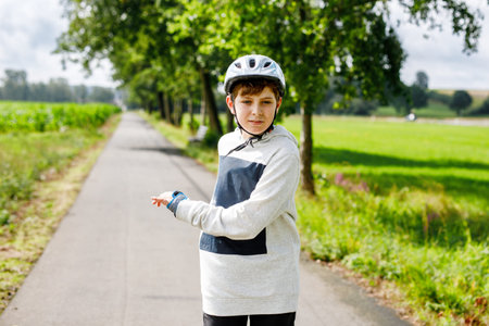 Active school boy skating in summer park, healthy lifestyle for children. Happy teenager with inline...