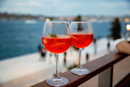 two aperol spritz on a summer evening in a mediterranean restaurant.の写真素材