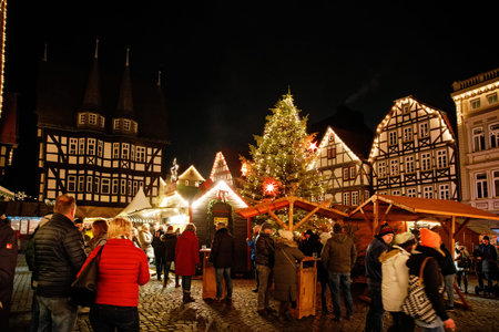 ALSFELD, GERMANY - 9 December, 2022: : Old market place with the christmas decoration, old houses with stores, restaurants and visitors of the christmas market. Traditional Christmas marketのeditorial素材