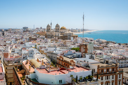 Aerial panoramic view of the old city rooftops and Cathedral de Santa Cruz in the afternoon from tower Tavira in Cadiz, Andalusia, Spainの写真素材