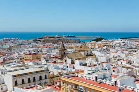 Aerial panoramic view of the old city rooftops and Cathedral de Santa Cruz in the afternoon from tower Tavira in Cadiz, Andalusia, Spainの写真素材