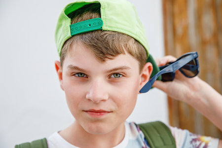 Portrait of preteen school kid boy. Beautiful happy child looking at the camera. Schoolboy smiling. Education concept.の写真素材