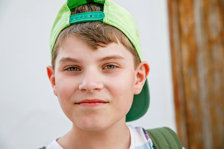 Portrait of preteen school kid boy. Beautiful happy child looking at the camera. Schoolboy smiling. Education concept.の写真素材
