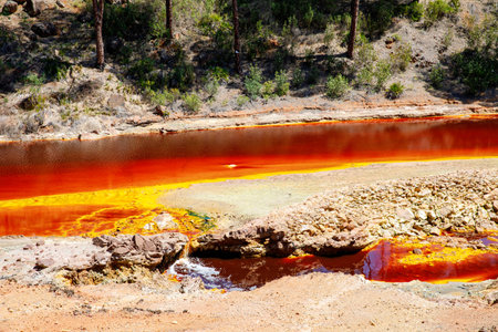 Rio Tinto river and iron mines. Red tinted river by copper, iron on the ground. Water used in life study for life detection in Mars.の写真素材