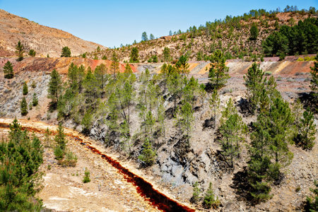 Rio Tinto river and iron mines. Red tinted river by copper, iron on the ground. Water used in life study for life detection in Mars.の写真素材