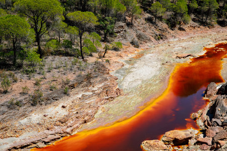 Rio Tinto river and iron mines. Red tinted river by copper, iron on the ground. Water used in life study for life detection in Mars.の写真素材