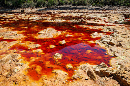 Rio Tinto river and iron mines. Red tinted river by copper, iron on the ground. Water used in life study for life detection in Mars.の写真素材