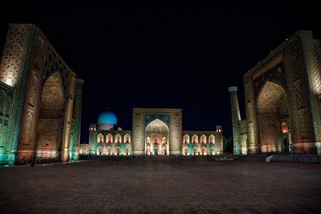 Colorful Registan square in Samarkand, Uzbekistan. Samarqand by night. In old arabic on the wallsの写真素材