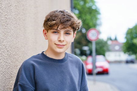 Portrait of smiling teenage schoolboy looking at camera. Happy teenage boy, smiling confidently into the camera. Portrait of a school kid enjoying student life. Education and youth lifestyle concept.の写真素材