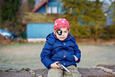 Little preschool boy of 4 years in pirate costume, outdoors. Happy child celebrating carnival called Fasching in Germanの写真素材