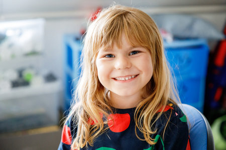 Portrait of a cute little girl. Happy smiling preschool child laughing. Childhood concept.の写真素材