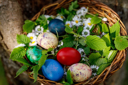 A basket of colorful Easter eggs surrounded by vibrant flowers and green grass, celebrating the joy...