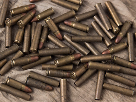A lot of pistol bullets and lies on a rag.の写真素材
