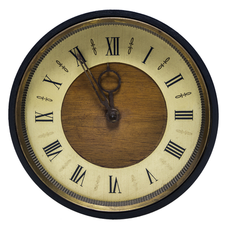 On a very old clock with Roman numerals, it's fifty-five minutes to twelve.の写真素材