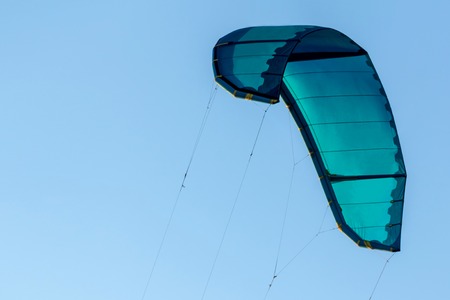 Sport turquoise kite for surfing in the air.の写真素材