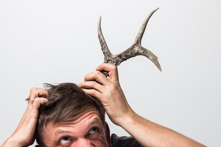 The concept. Treason of the wife. On the head of her husband grew a deer horn.の写真素材